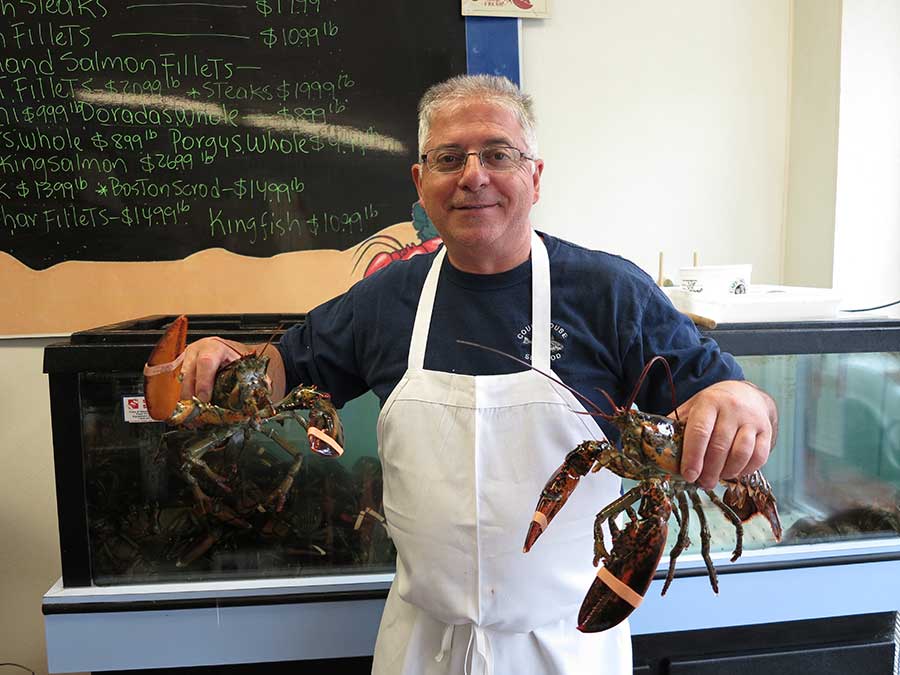 Eddie holding live lobsters